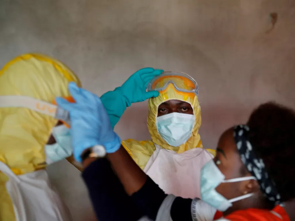 etugas kesehatan menyesuaikan perlengkapan saat pemakaman seseorang yang diduga meninggal karena Ebola di Beni, Provinsi Kivu Utara Republik Demokratik Kongo, (REUTERS/Goran Tomasevic/File Photo)