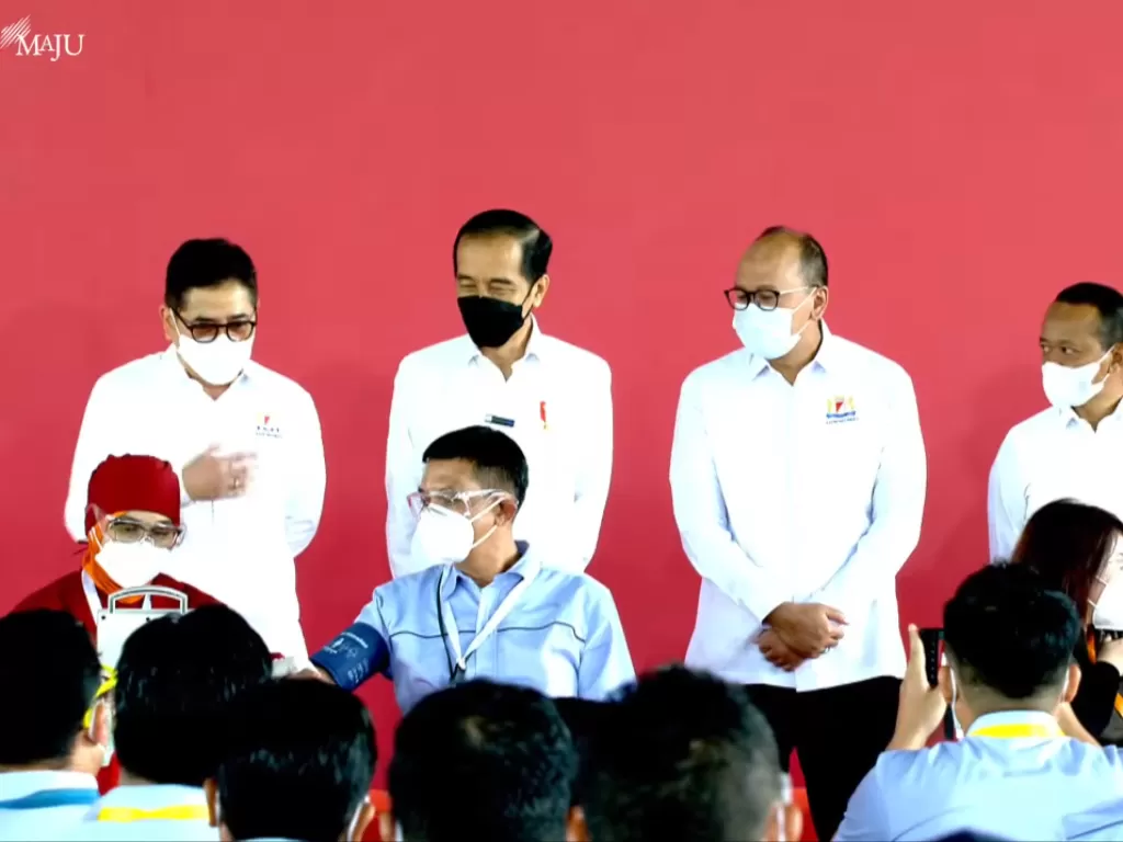Tangkapan Layar: Presiden Jokowi (berdiri kedua dari kiri) saat meninjau Vaksinasi Gotong Royong perdana di kawasan industri Jababeka, Bekasi, Jawa Barat, Selasa (18/5). (Youtube Sekretariat Presiden)