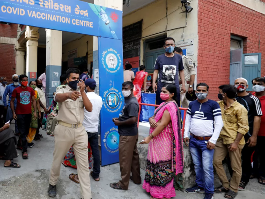 Sejumlah warga di Ahmedabad, India sedang mengantri untuk menerima vaksin Covid-19. (REUTERS/Amit Daveyang)