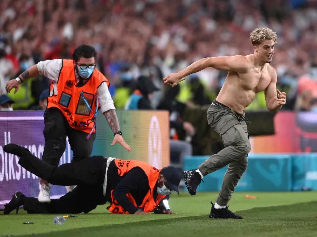 Penyusup pria bertelanjang dada di final EURO 2020. (photo/REUTERS/LAURENCE GRIFFITHS)