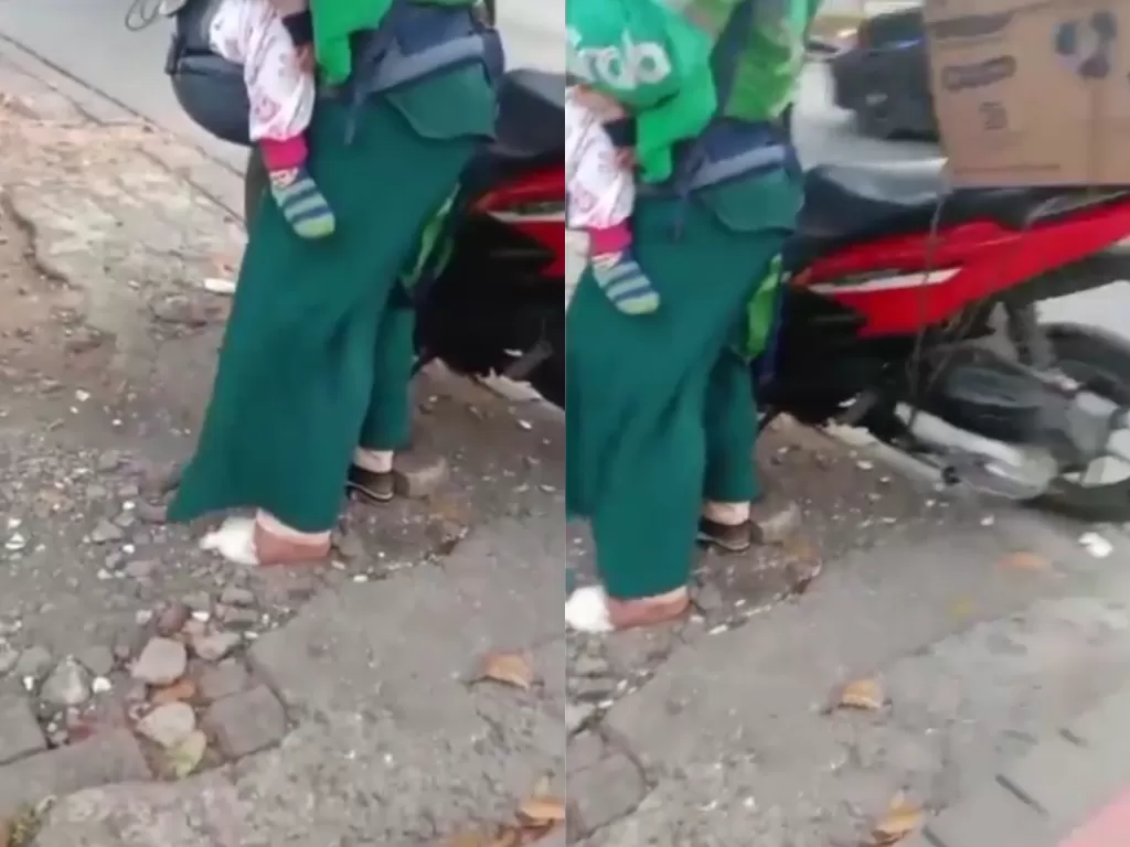 Ibu ojol gendong anaknya sambil bekerja dengan kaki sebelahnya diperban (Instagram/kamerapengawas)