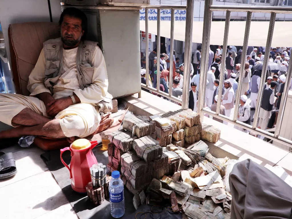 Pria yang berprofesi sebagai penukar uang di Afghanistan (REUTERS/Stringer)
