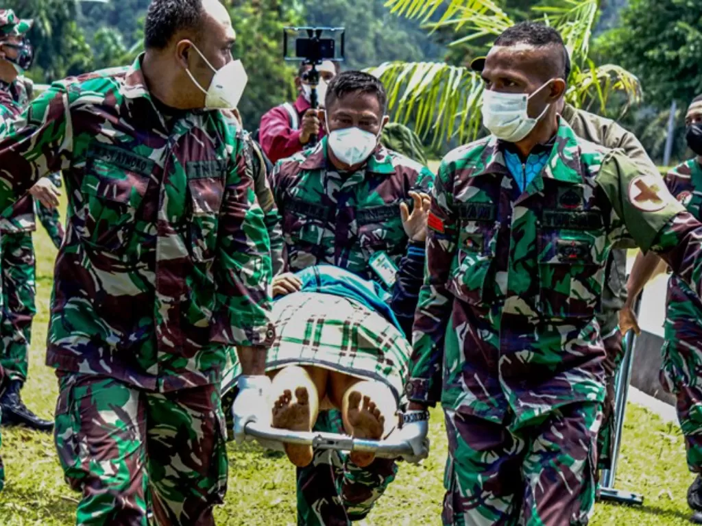 Prajurit TNI AD menggotong Nakes korban penyerangan KKB. (ANTARA FOTO/Indrayadi TH) 