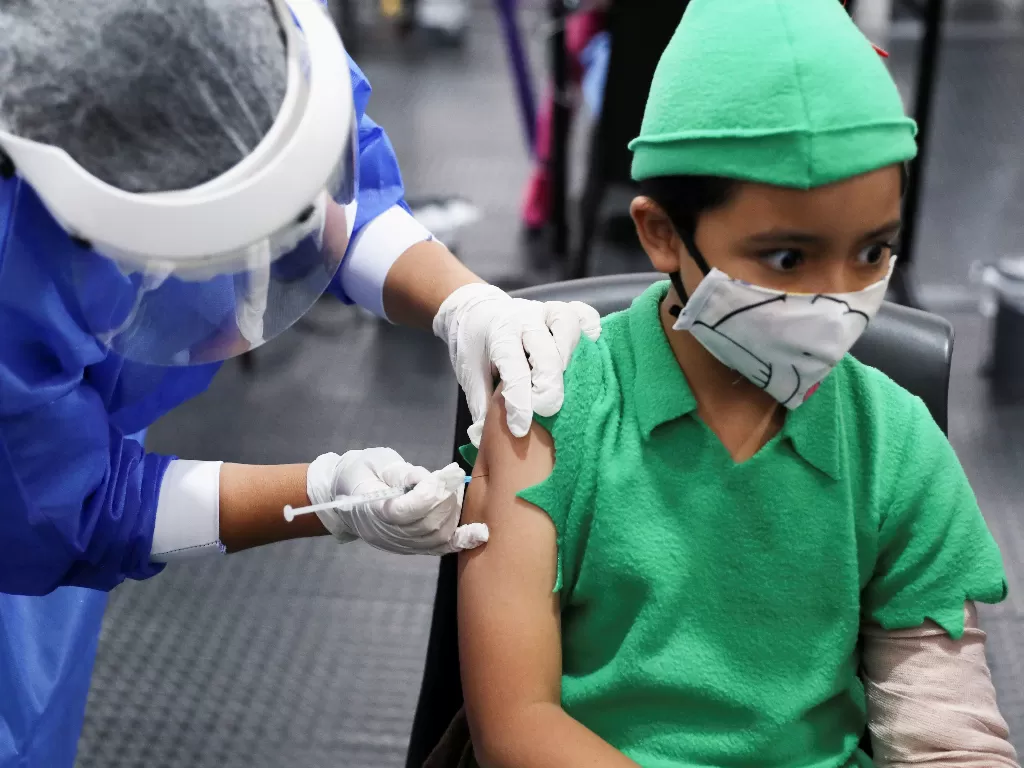 A boy dressed as Peter Pan receives his first dose of China's SINOVAC vaccine against the coronavirus disease (COVID-19) as the Colombian government begins a vaccination campaign for kids, in Bogota, Colombia. (REUTERS/LUISA GONZALEZ)