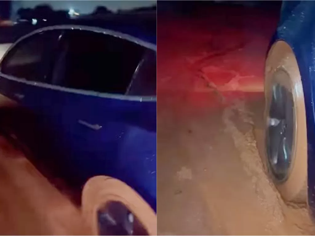 Mobil listrik Tesla milik Indra Kesuma terjebak endapan lumpur di sebuah ruas jalan. (Instagram/Indrakenz)
