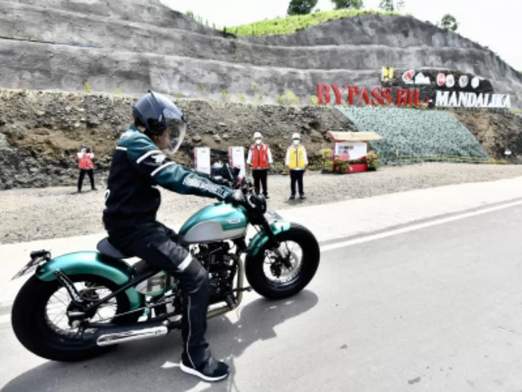 Presiden Joko Widodo mengendarai motor Kawasaki W175 custom saat kunjungan kerja di Kawasan Ekonomi Khusus (KEK) Mandalika, Desa Kuta, Kecamatan Pujut, Kabupaten Lombok Tengah, Kamis (13/1/2022). (ANTARA FOTO/Setpres-Agus Suparto)