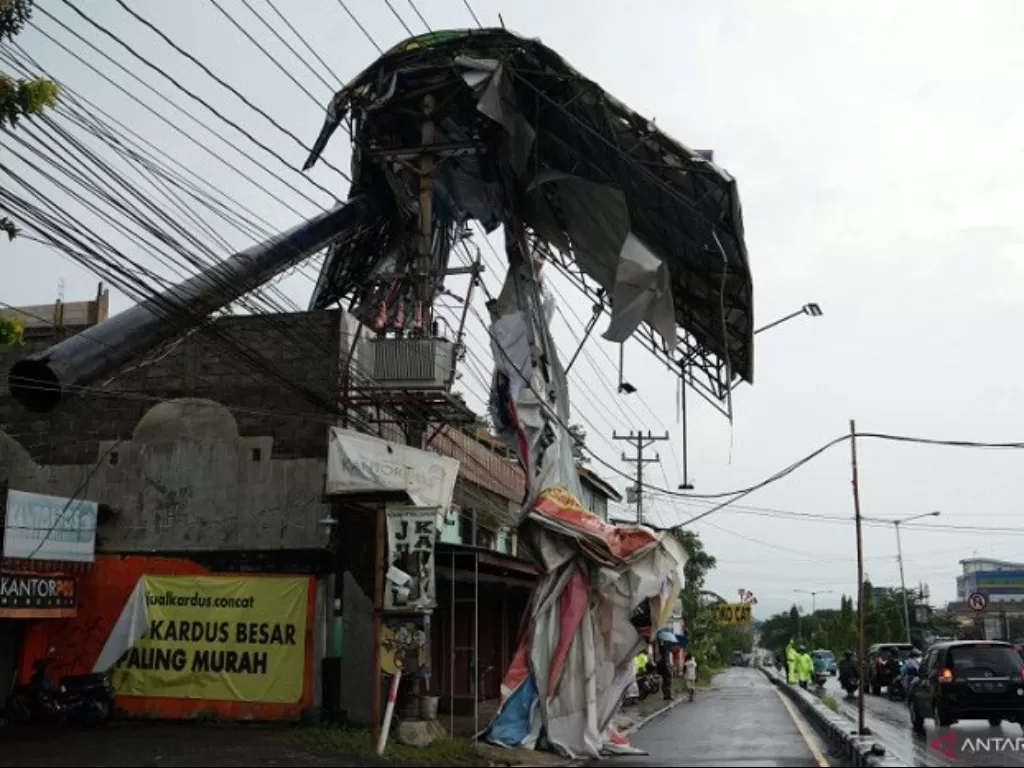 Polisi berjaga di dekat baliho yang roboh akibat diterjang angin kencang di kawasan Condongcatur, Sleman, D.I Yogyakarta. (ANTARA/Andreas Fitri Atmoko)