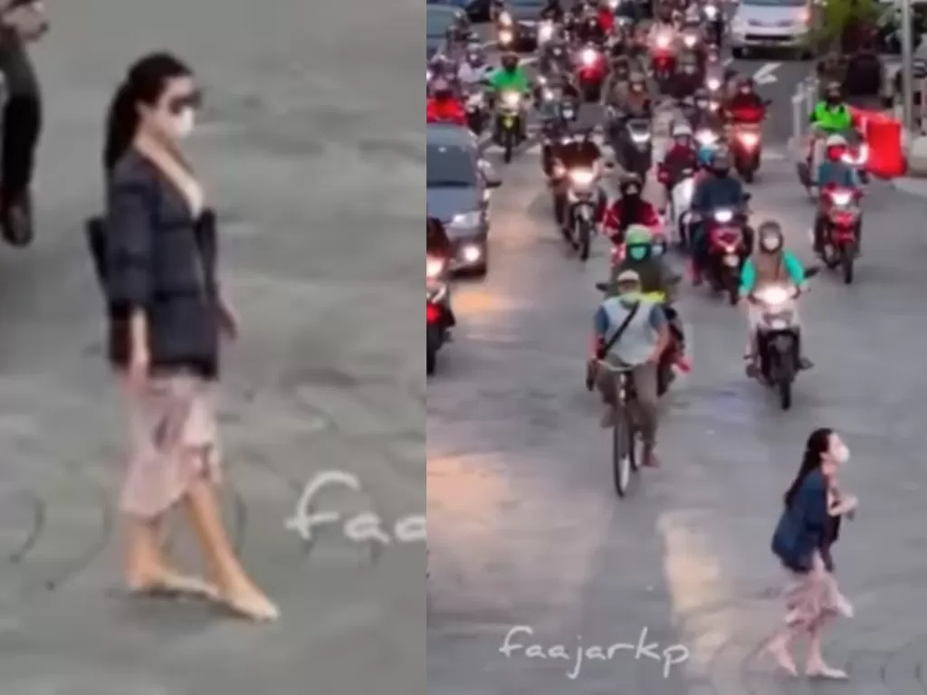 Tangkapan layar wisatawan wanita asyik foto di tengah jalan di kawasan Tugu Jogja. (Instagram @faajarkp)