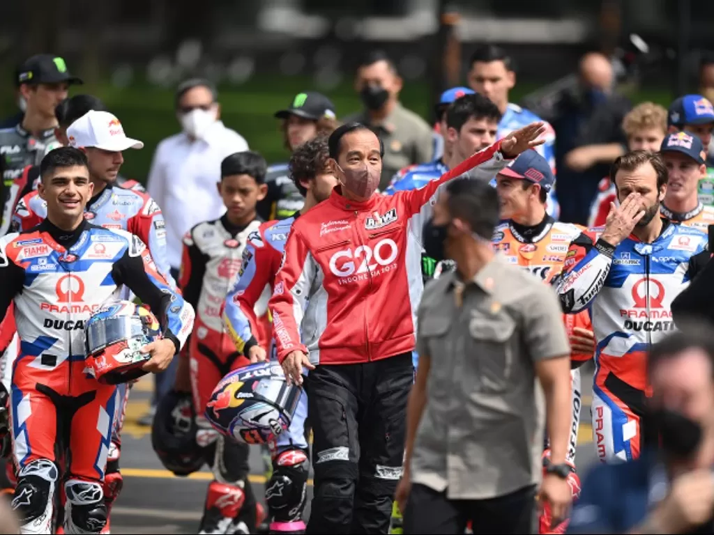 Presiden Joko Widodo (tengah) berjalan bersama para pembalap MotoGP sebelum melepas parade Moto GP di depan Istana Merdeka. (ANTARA FOTO/Sigid Kurniawan)