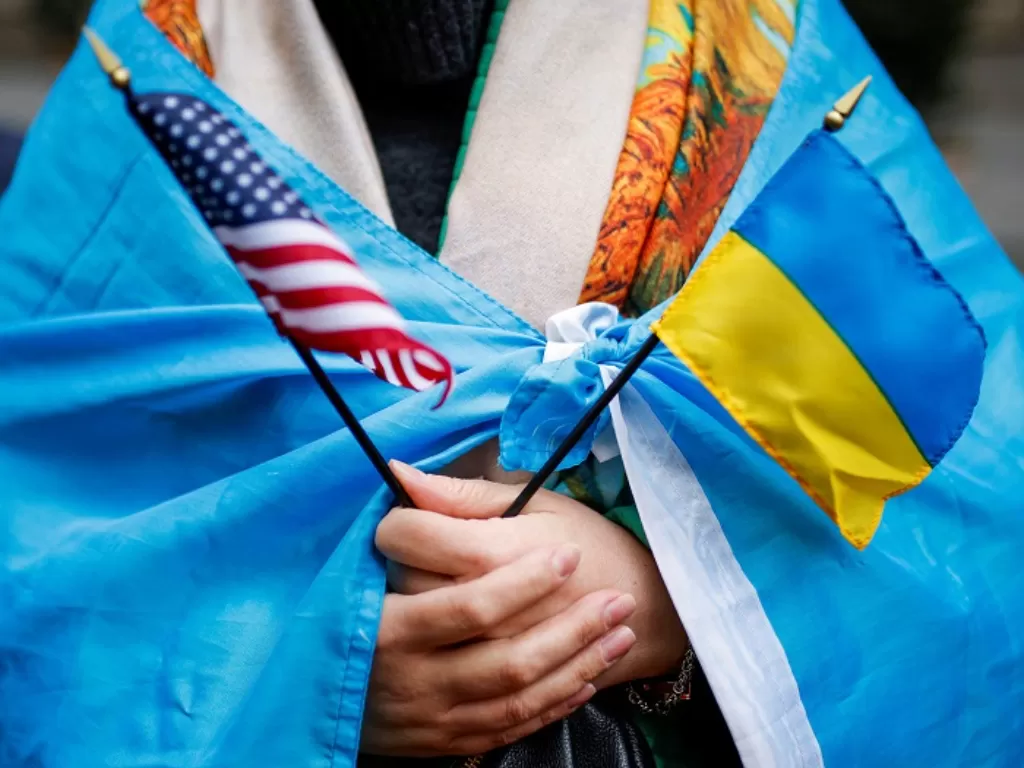 Seorang warga New York menyandingkan bendera AS dan Ukraina sebagai bentuk penolakan invasi Rusia. (REUTERS/Eduardo Munoz)