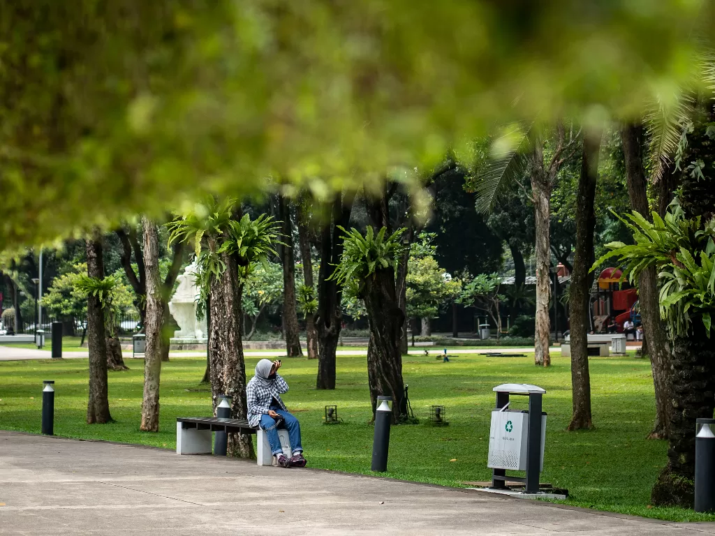 Warga duduk di Taman Lapangan Banteng. (ANTARA/Aprillio Akbar)