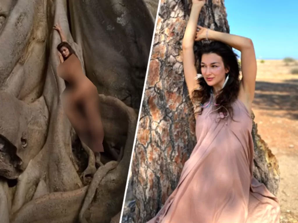Model asing pemilik akun alina_yogi yang diduga berasa dari Rusia tengah berpose tanpa busana di sebuah pohon besar di Bali. (Instagram/Taplink/alina_yogi)