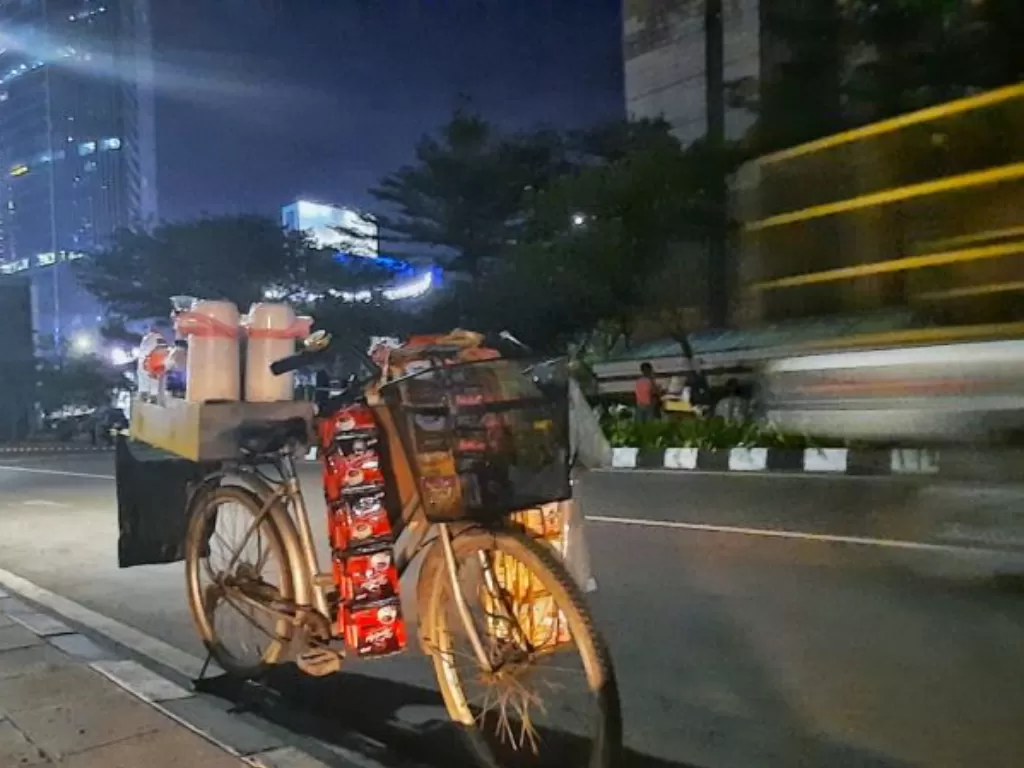Pedagang kopi dengan menggunakan sepeda di kawasan Sudriman, Jakarta pusat, Senin (4/7/2022). (ANTARA/Chairul Rohman)