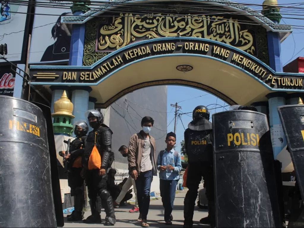 Polisi berjaga di depan gerbang Ponpes Shiddiqiyyah Ploso saat proses upaya penangkapan Moch Subchi Azal Tsani di Jombang, Jawa Timur. (ANTARA FOTO/Syaiful Arif)