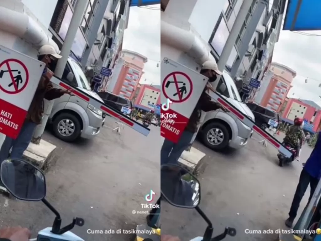 Pria yang bertugas memegangi palang pintu parkir di Tasikmalaya. (Instagram/bogordailynews)