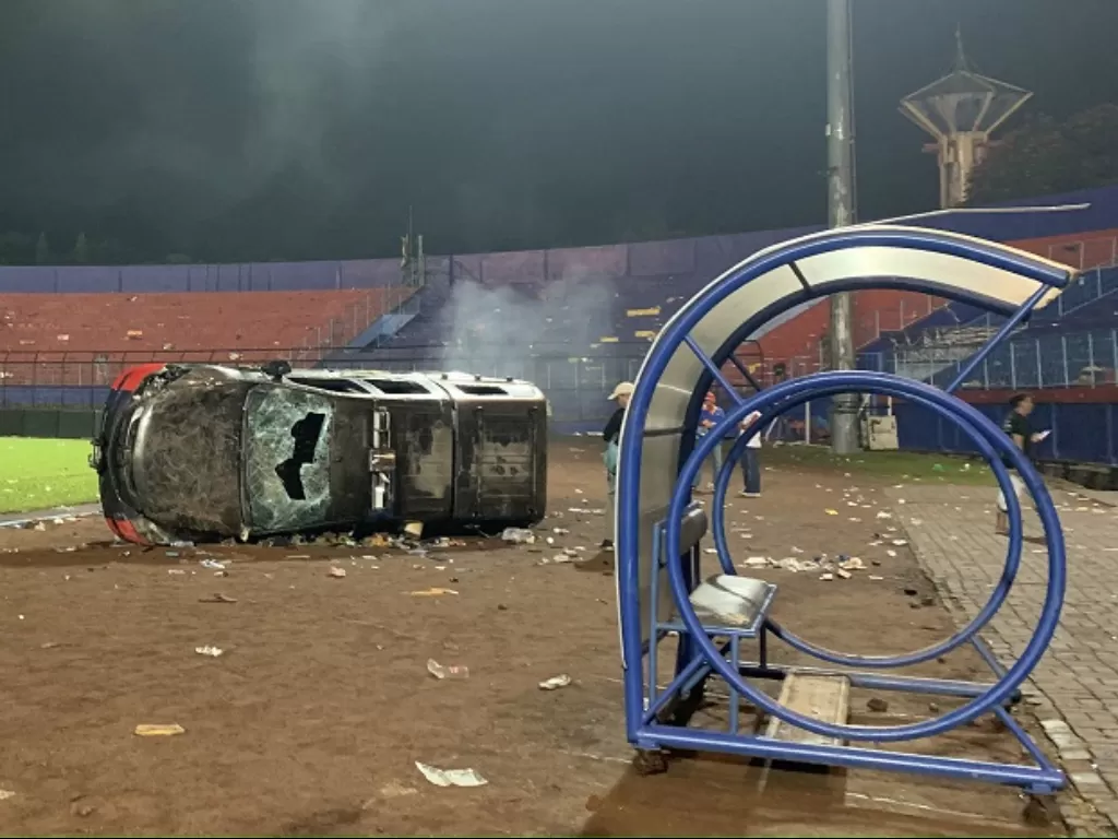 Sebuah mobil Polisi dibakar oleh oknum pendukung Arema FC dalam kericuhan di Stadion Kanjuruhan. (ANTARA FOTO/Vicki Febrianto)