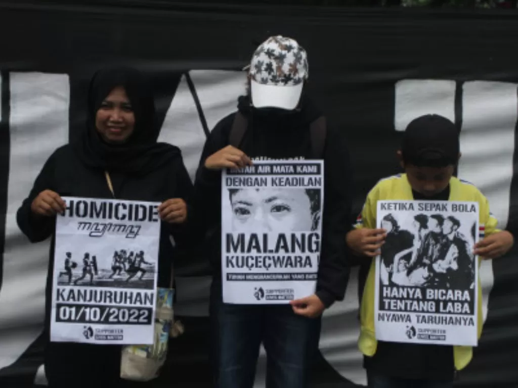 Ilustrasi suporter Arema FC (Aremania) membawa poster saat berunjukrasa memblokir jalan di Malang, Minggu (20/11/2022). (ANTARA FOTO/Ari Bowo Sucipto)