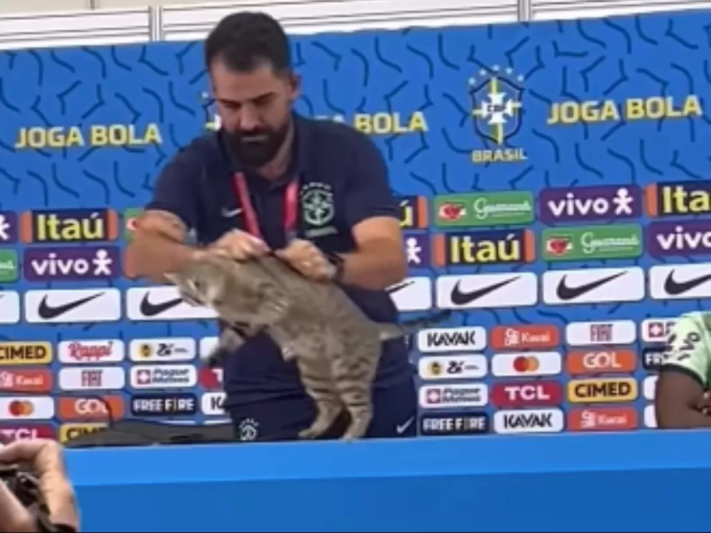 Momen salah satu tim official Brasil lempar kucing dari atas meja, ketika timnas Brasil tengah konferensi pers dengan wartawan di Qatar, baru-baru ini. (Instagram/faktabola)