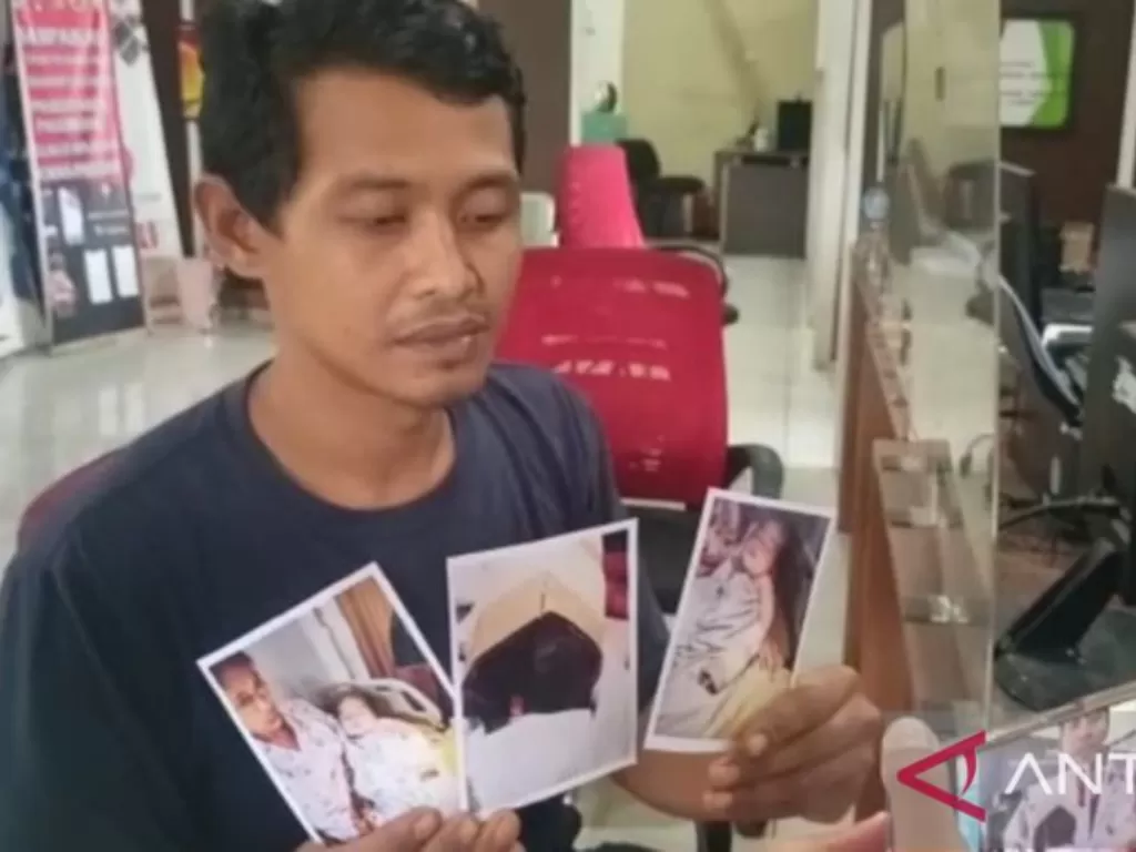 Suparman (38) menunjukkan foto anak bayinya yang terluka pada jari tangan bagian kelingkingnya akibat guntingan oknum perawat DN, saat membuat laporan di SPKT Polres Kota Besar Palembang, Sumatera Selatan, Sabtu (4/2/2023). (ANTARA/M Riezko Bima Elko P)