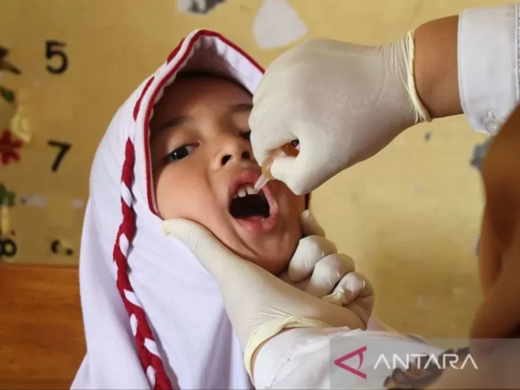   Petugas kesehatan memberikan tetesan vaksin polio tahap dua kepada pelajar di Sekolah Dasar Negeri 7, Banda Aceh, Senin (13/2/2023). (ANTARA FOTO/Ampelsa)