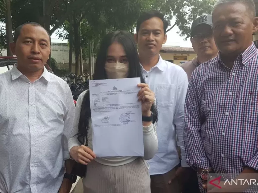 Korban kasus dugaan pelecehan seksual karyawati perusahaan AD (24) menunjukkan bukti laporan di Mapolres Metro Bekasi pada Sabtu (6/5/2023). (ANTARA/Pradita Kurniawan Syah)