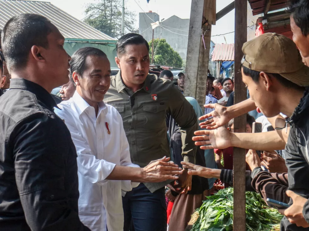 Presiden RI, Joko Widodo saat membagikan BLT ke pedagang di Bogor. (ANTARA FOTO/Yulius Satria Wijaya)