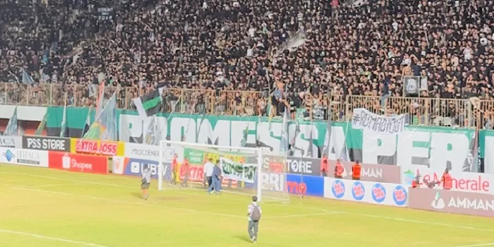   PSS Fans memasang spanduk di gawang sisi selatan. (Harminanto) 