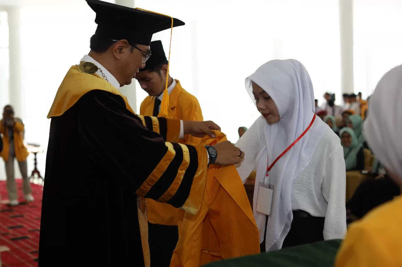 Rektor secara simbolis memberikan jaket almamater kepada mahasiswa baru