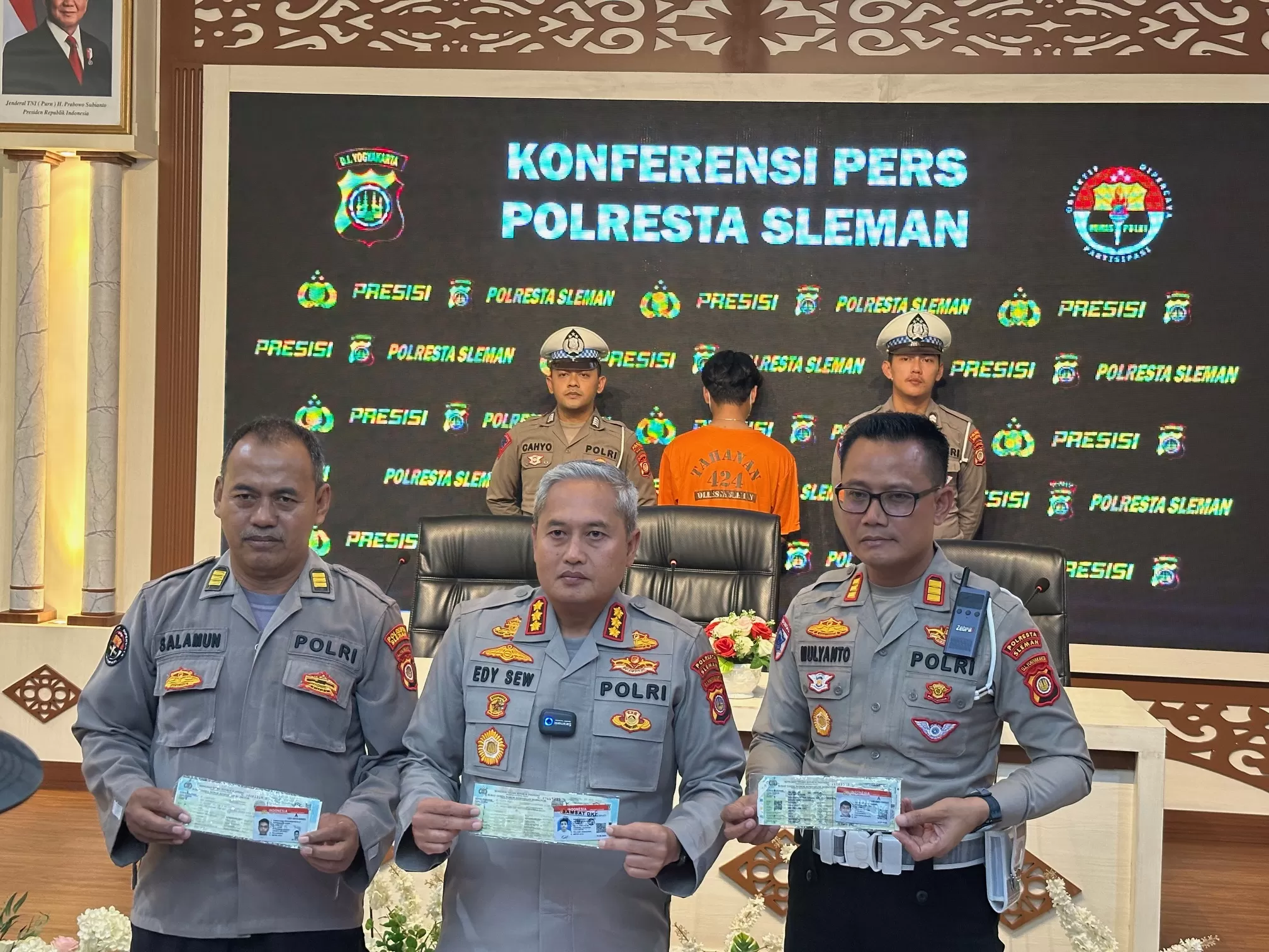   Polisi menunjukkan barang bukti yang diamankan dengan latar tersangka mengenakan baju oranye (Harminanto)