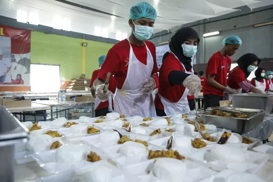 Petugas katering mengepak konsumsi untuk kebutuhan panitia dan petugas pendukung di dapur Peparnas XVII, Baturan, Karanganyar, Jumat, (4/10/2024).  (Foto: PB Peparnas XVII/Yoma Times Suryadi)