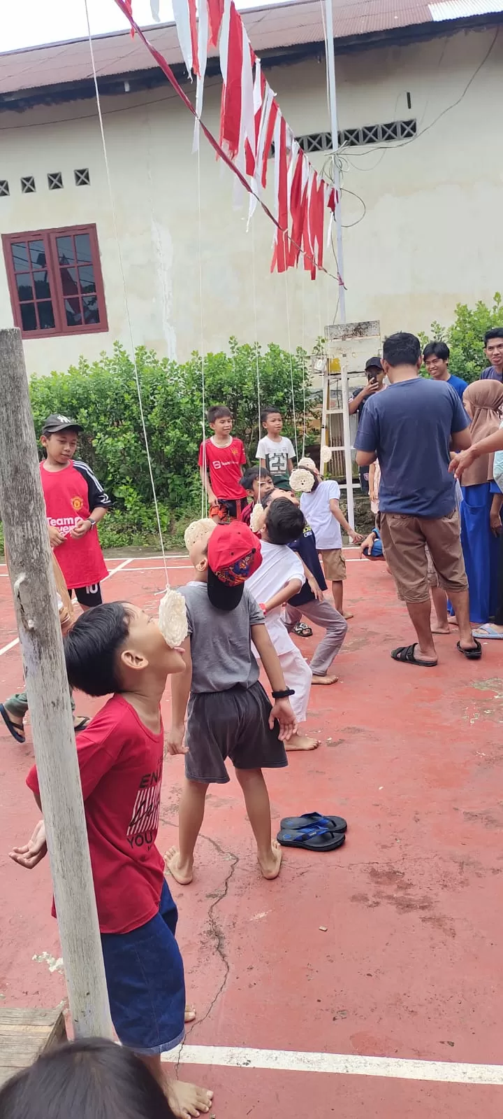 MERIAH: Anak-anak di RT 58, Kelurahan Graha Indah, Balikpapan, mengikuti lomba makan kerupuk, Minggu (18/8/2024). (WARGA RT 58 FOR PROKAL.CO)
