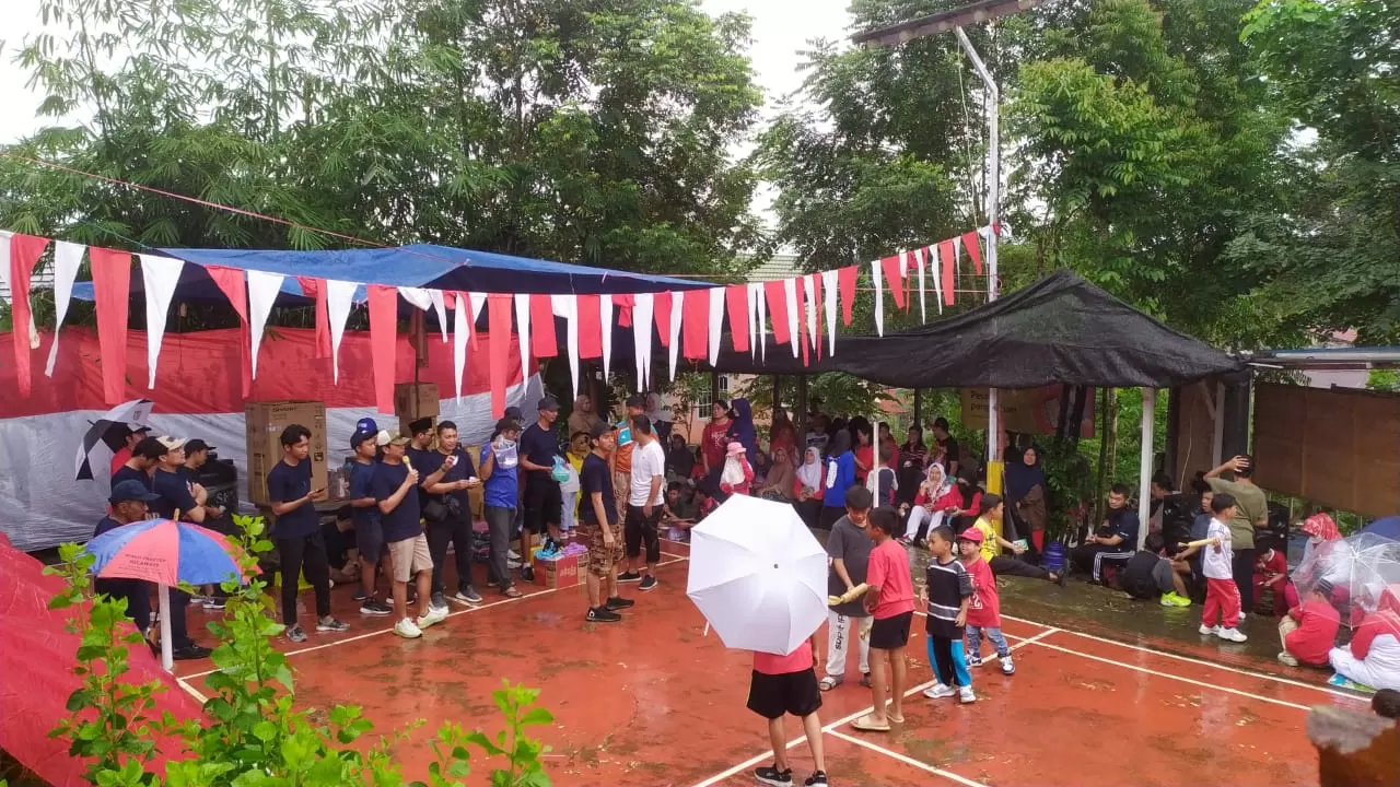 ANTUSIAS: Warga RT 58, Kelurahan Graha Indah, Balikpapan Utara, Kota Balikpapan, antusias mengikuti rangkaian jalan sehat, Minggu (25/8/2024). Tampak suasana pembagian hadiah sempat gerimis.  (WARGA RT 58)