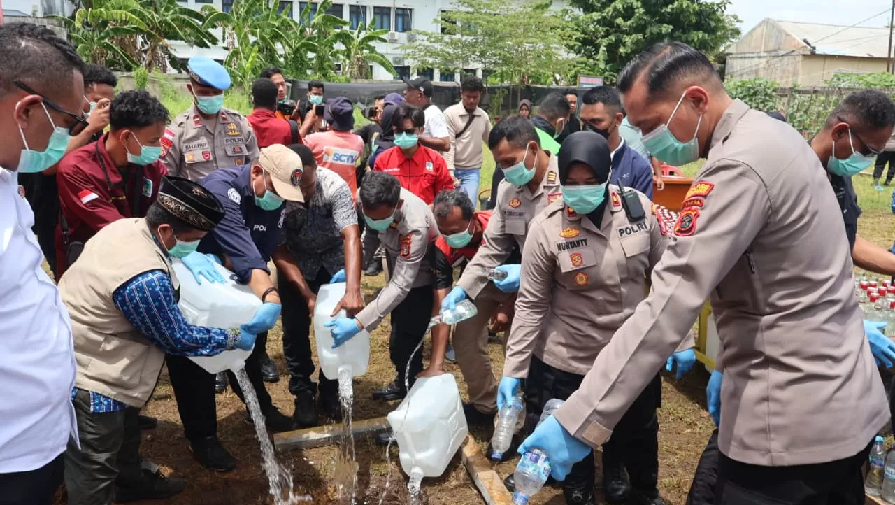 Kapolres Merauke, AKBP Leinardo Yoga bersama stakeholder saat memusnahkan ribuan liter miras ilegal dan sopi hasil razia dan operasi, Kamis (6/11/2025).(Ceposonline.com/Sulo).