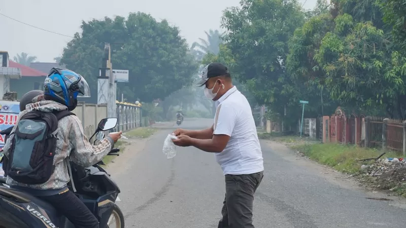 Pembagian 50.000 masker kepada masyarakat terdampak kabut asap di Dharmasraya. (Foto: Kominfo Dharmasraya)