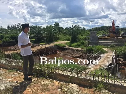 PENINGKATAN FASUM: Ketua DPRD Paser, Hendra Wahyudi meninjau pengerjaan Jembatan Sungai Payo, Kecamatan Long Ikis.