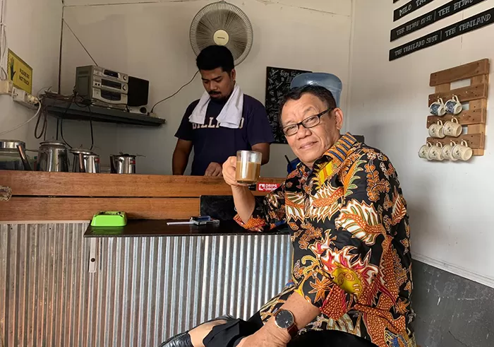 KOPI: Penulis menikmati kopi di Warung Pagi-Sore, Jalan Durian III. Latar belakang Mas Teguh, sang pemilik warung.