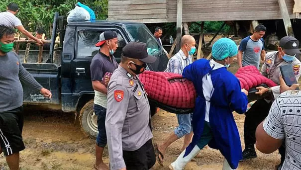 MENGGOTONG: Personel Polsek Gunung Tabur bersama BPBD Berau dibantu masyarakat, saat menggotong jenazah MN (39) pada Rabu (7/4).