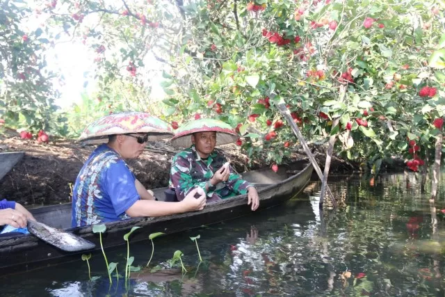MERAH RANUM: Wali Kota Banjarmasin Ibnu Sungai menyusuri Sungai Biuku. Di tepian sungai, tumbuh pohon-pohon rambutan. Sudah merah dan siap dipetik.