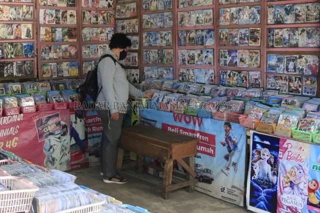 SEPI: Salah seorang calon pembeli kaset kepingan di kawasan Pasar Bauntung Banjarbaru memilih jenis kaset yang ingin dibelinya. Kini, penjualan kaset konvensional ini terus menurun digempur kemajuan teknologi yang kian masif, ditambah pandemi Covid-19. | Foto: Muhammad Rifani/Radar Banjarmasin