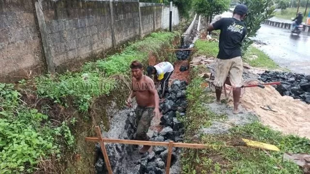 KEJAR TAYANG: Pekerjaan drainase di Jalan Guntung Manggis, Kecamatan Landasan Ulin, kemarin. Proyek dalam program padat karya ini sedang dikejar waktu, karena harus selesai pada tahun ini. | FOTO: SUTRISNO/RADAR BANJARMASIN