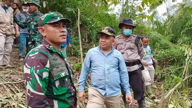 EVAKUASI: Bupati Sudian Noor turun ke lapangan, membantu proses evakuasi korban longsor di tambang manual Kecamatan Mantewe, Senin (25/1)