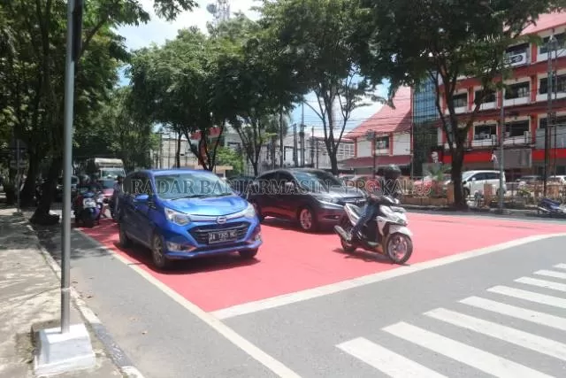 RUANG HENTI: Selama lampu merah menyala, marka merah ini buat pesepeda motor saja. Sementara mobil dan truk wajib menunggu di belakangnya. | FOTO: TIA LALITA NOVITRI/RADAR BANJARMASIN