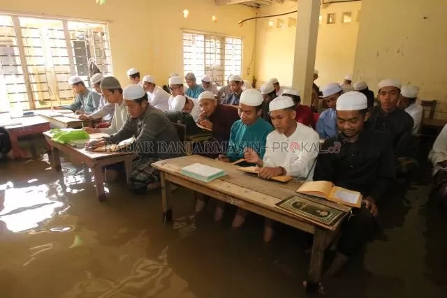 TETAP BELAJAR: Pondok Pesantren Syekh Muhammad Arsyad Al Banjari Desa Dalam Pagar melaksanakan kegiatan belajar mengajar kendati tergenang.