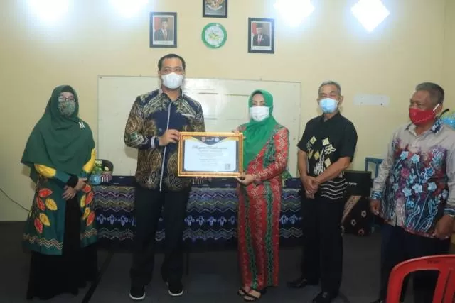 JUARA: Wali Kota Banjarbaru H M Aditya Mufti Ariffin SH MH saat menyerahkan penghargaan Lomba Kampung KB Berprestasi Tingkat Provinsi Tahun 2020 kepada Kampung KB Kuranji yang meraih Juara I, Jumat (2/4) tadi. | FOTO: HUMAS DAN PROTOKOL PEMKO BANJARBARU