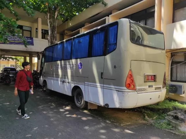 ASET KENDARAAN: Bus milik Dinas Kominfo HST yang terparkir di belakang kantor BPKAD HST. Dilihat dari pelat, pajak kendaraan ini mati bulan September tahun 2021.