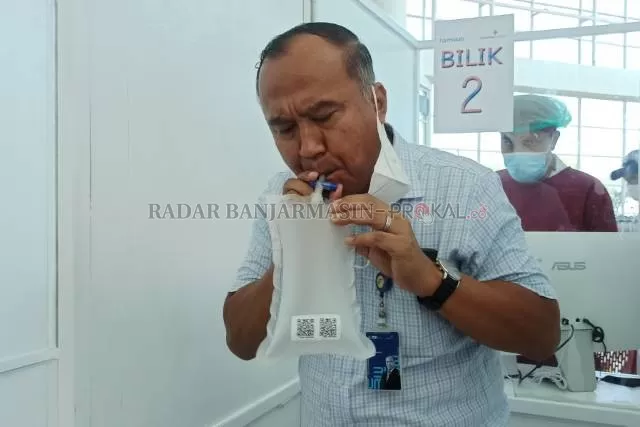 EMBUS: Penumpang di Bandara Syamsudin Noor, Banjarbaru mencoba GeNose C19 sebagai deteksi dini penularan corona. | FOTO: SUTRISNO/RADAR BANJARMASIN