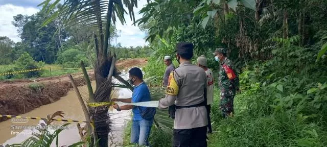 TEMPAT KEJADIAN: Jajaran Polsek Tapin Tengah bersama TNI dan warga memasang garis polisi di lokasi kejadian tenggelamnya dua anak. | Foto: Polsek Tapin Tengah for Radar Banjarmasin