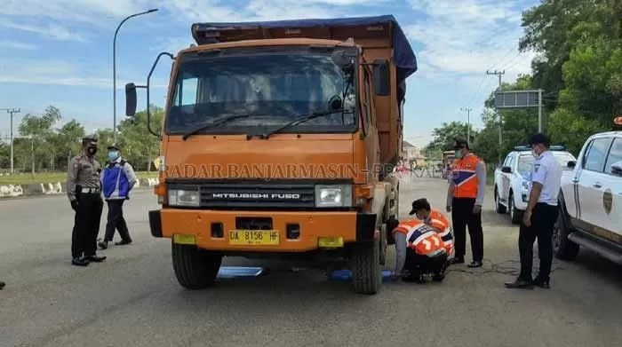 DIPERIKSA: Truk angkutan yang melintas di Jalan Trikora Banjarbaru dicek petugas gabungan terkait muatan dan tonase. | Foto: Muhammad Rifani/Radar Banjarmasin