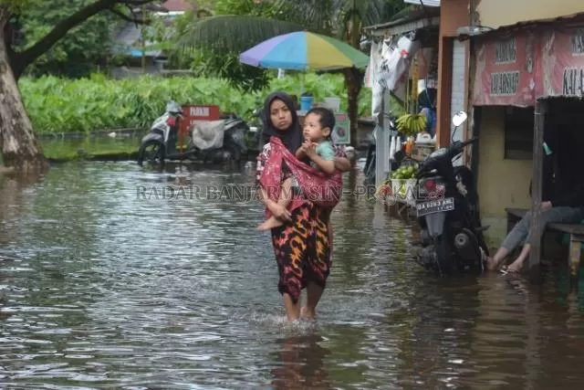 KAPAN SURUT: Genangan di Jalan Prona I di Banjarmasin Selatan tak kunjung surut. Warga menuntut sungai di sana dikeruk.
