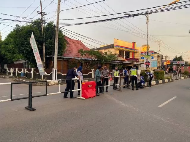 DITUTUP: Petugas dari Dishub Tala dibantu Satlantas Polres Tala melakukan penutupan perempatan Jalan Pancasila, Kamis (16/12)